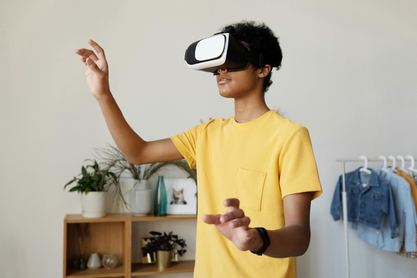 Tiener met VR-bril die met haar handen in de lucht beweegt